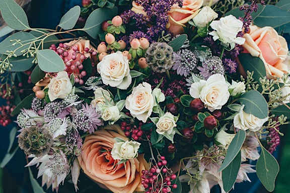 a bouquet of flowers and berries on a table