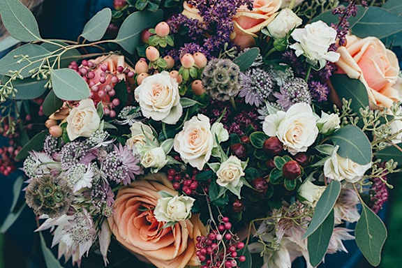 a bouquet of flowers and berries on a table