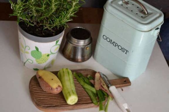 a cutting board with some vegetables on a table