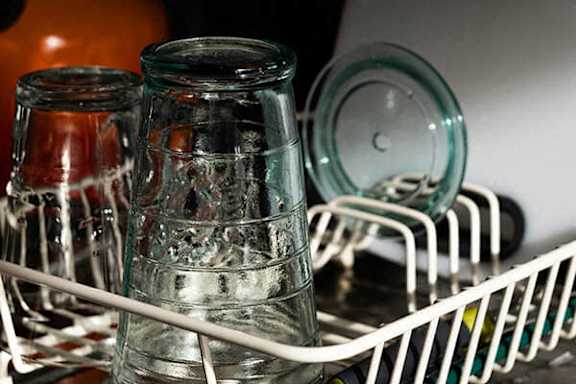 Glass jars in a dishwasher rack.
