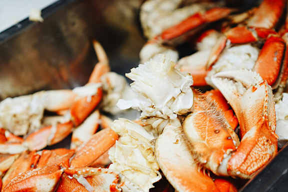 A close up of cooked crabs in a pan.