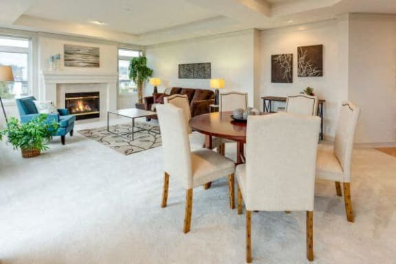 a living room with a table and chairs