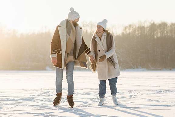 Two people walking in the snow.