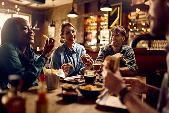 A group of people are enjoying a meal together in a restaurant.