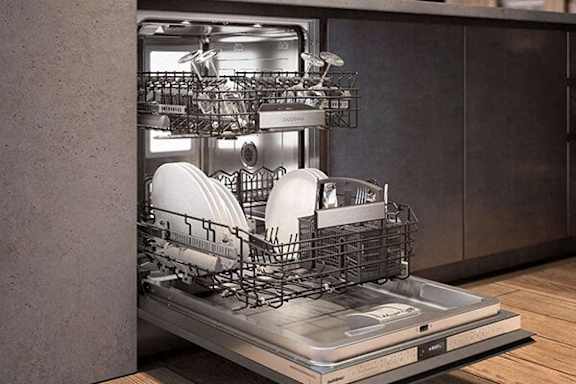 A dishwasher with a full rack of dishes is placed in a kitchen.