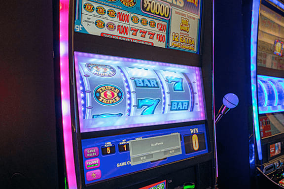 A slot machine with a 7 on the screen and a win message.