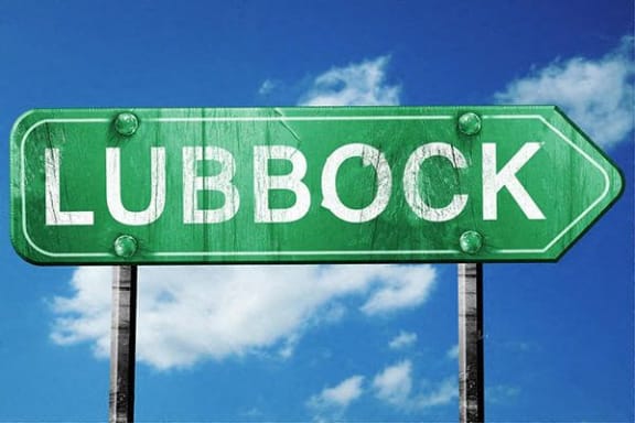 a green street sign that reads lubbock
