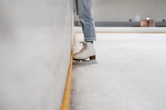 a person wearing ice skates standing on a wall