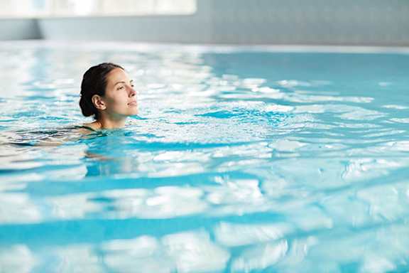 A person is swimming in a pool.