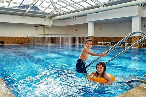 a boy and a girl in a swimming pool