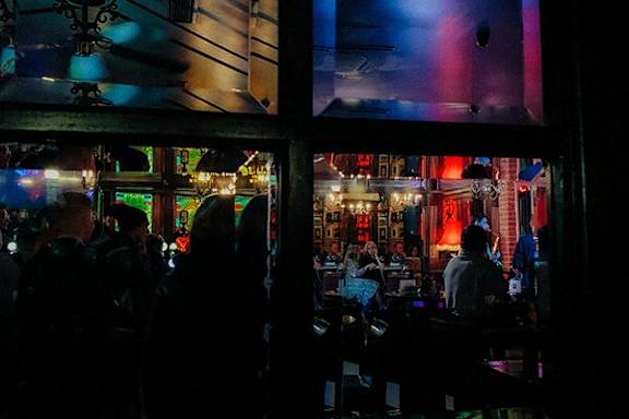 A group of people are sitting in a bar.