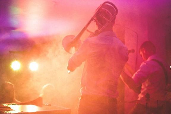 A man is playing a trombone on a stage.