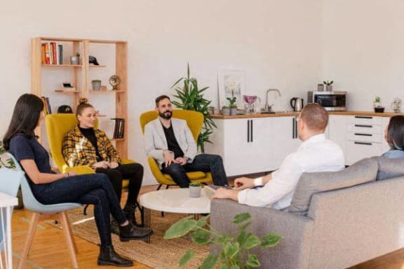 a group of people sitting in a living room