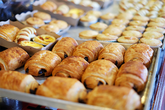 A tray of freshly baked croissants and other pastries.