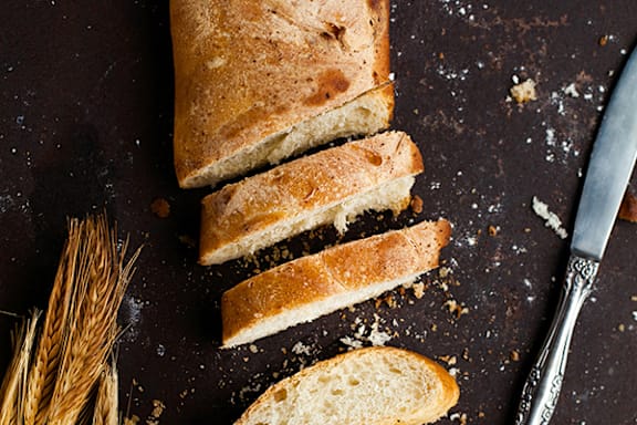 a loaf of bread cut in half on a cutting board