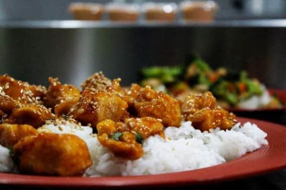 a plate of food with rice and chicken on it