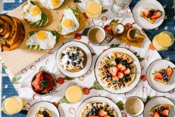 a table topped with plates of breakfast food