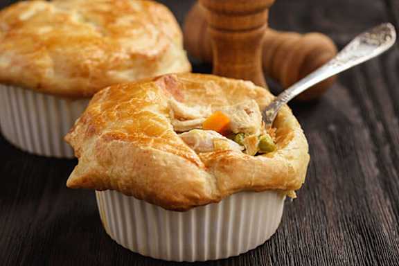 A close-up of a chicken pot pie with a spoon in it.