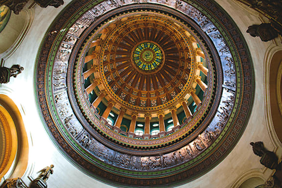 A beautifully decorated dome ceiling in a building.