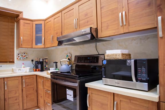 a kitchen with wooden cabinets and black appliances