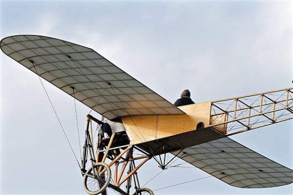a man sitting on top of a small airplane