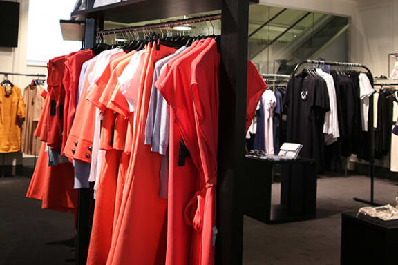 a rack of red clothes in a clothing store