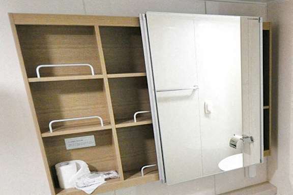 A white bathroom cabinet with a mirror and shelves.