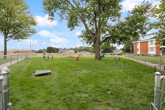 a park with a swing set and a seesaw