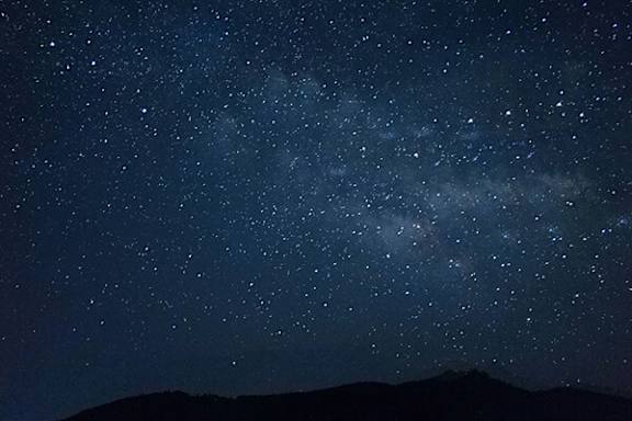 A night sky filled with stars and the Milky Way galaxy.