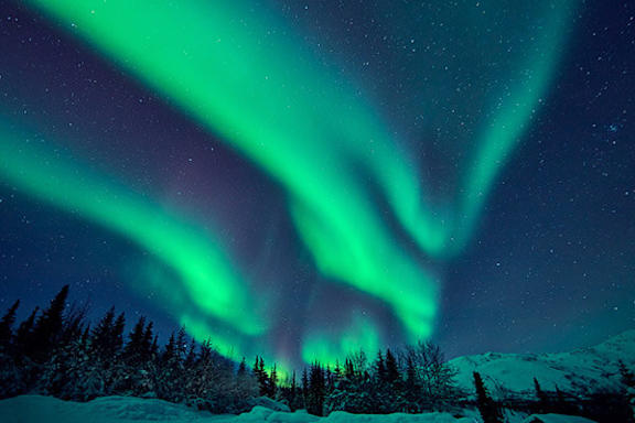 The image showcases a beautiful display of the Northern Lights in the night sky.