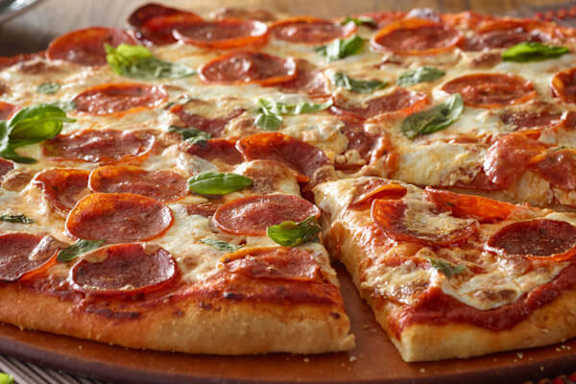 A pepperoni pizza with a slice missing.