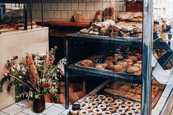 A bakery display case filled with various baked goods.