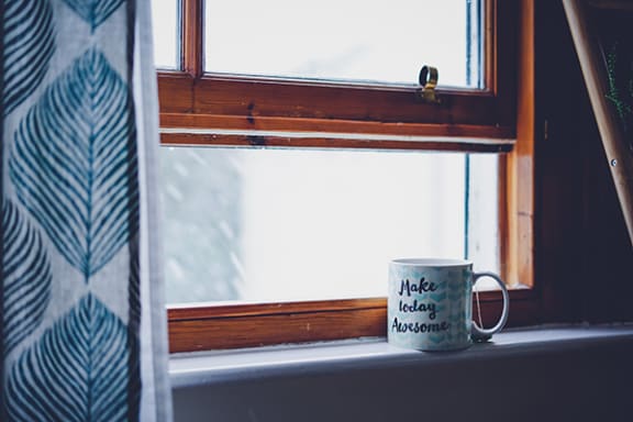a mug sitting on a window sill