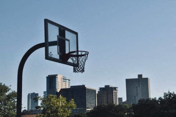 a basketball hoop with a city in the background