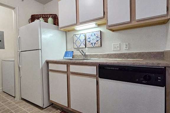 a kitchen with a sink and a refrigerator