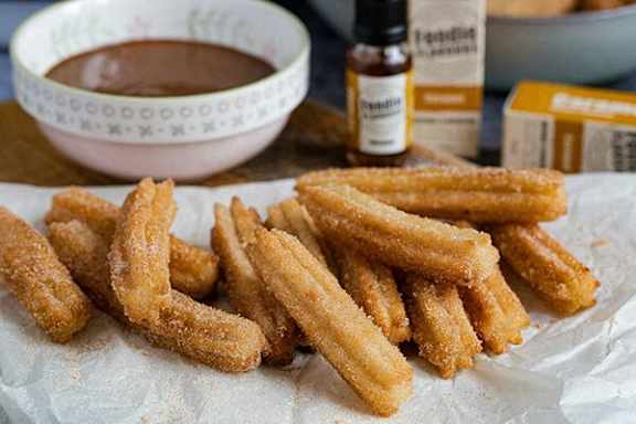 Churros are served with a chocolate dip.