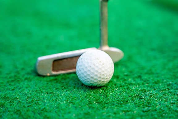 A golf ball is on a tee.