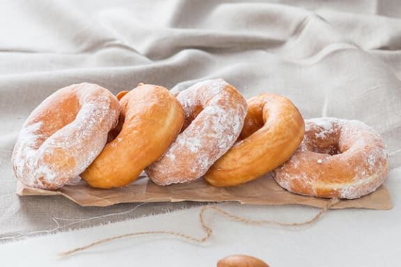 a pile of donuts sitting on top of a table