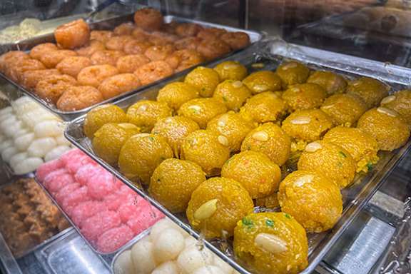 A display case filled with assorted Indian sweets.