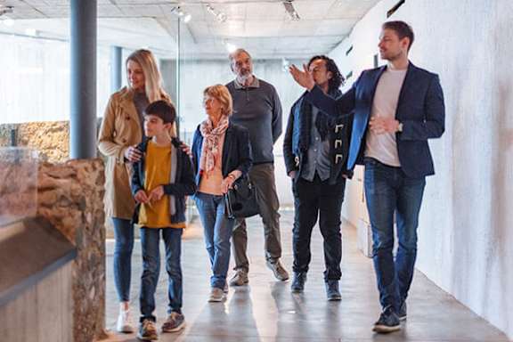 A group of people are walking in a hallway.