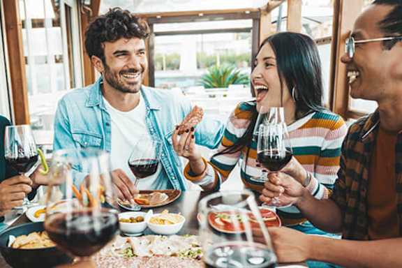 A group of people enjoying a meal and drinks together.