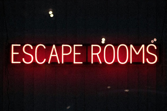 A red neon sign that says "Escape Rooms".