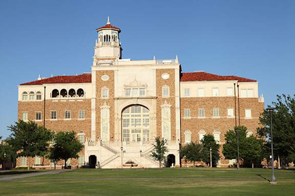 A large building with a tower and arched doorway.