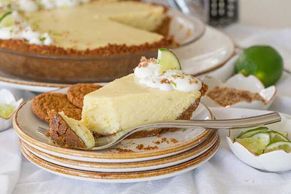 A slice of key lime pie on a plate with a fork.