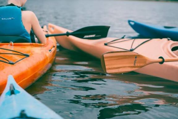 a woman is sitting in a kayak on the water