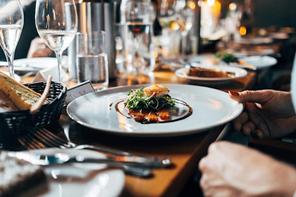A person is holding a plate with food on it.