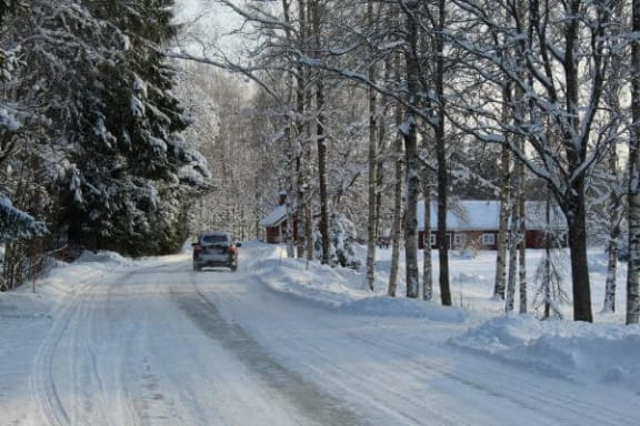 a car driving down a snow covered road