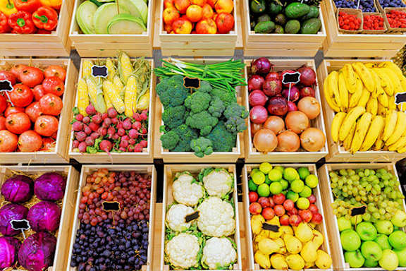 A display of fresh fruits and vegetables in a market.