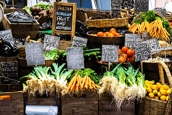 A market display of fresh vegetables and fruits.