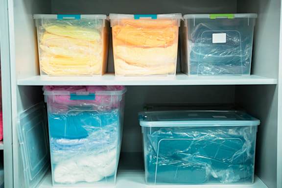 A refrigerator with four containers of food inside.